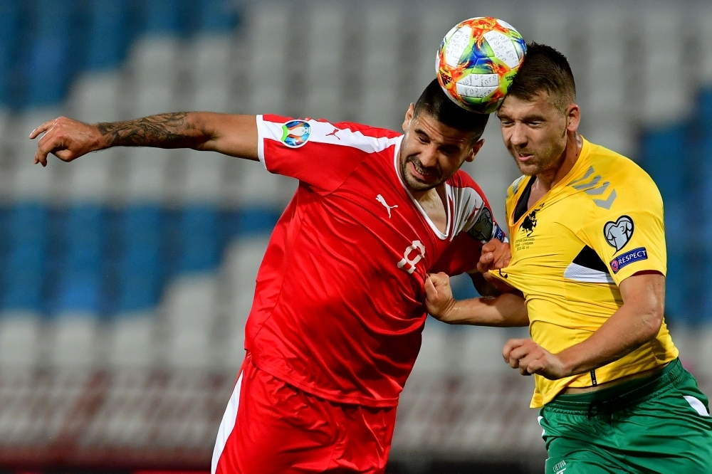 Serbia's Aleksandar Mitrovic (L) vies with Lithuania's Linas Klimavicius during the Euro 2020 football qualification match against Lithuania at the 