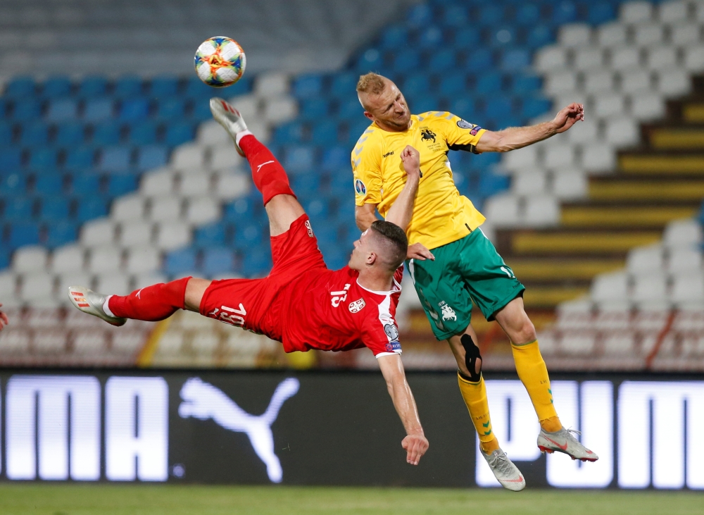 Serbia's Aleksandar Mitrovic (L) vies with Lithuania's Linas Klimavicius during the Euro 2020 football qualification match against Lithuania at the 