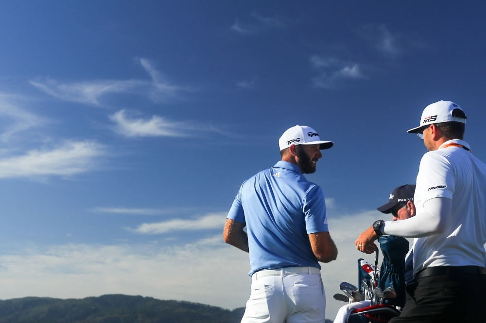 Dustin Johnson of the United States talks with caddie Austin Johnson on the fifth hole during a practice round prior to the 2019 US Open at Pebble Beach Golf Links on Tuesday in Pebble Beach, California. — AFP