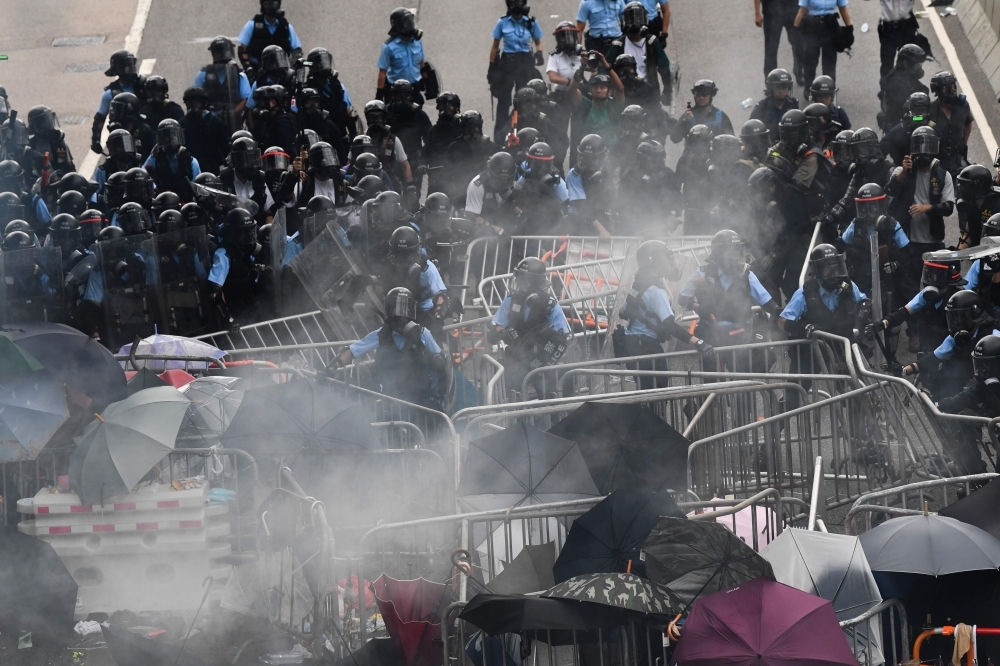 Police clash with protesters during a demonstration outside the government headquarters in Hong Kong on Wednesday. — AFP