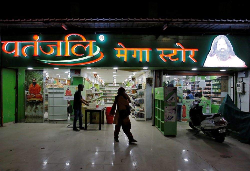 A hoarding with an image of Baba Ramdev is seen inside a Patanjali store in Ahmedabad, India, in this March 28, 2019 photo.  — Reuters