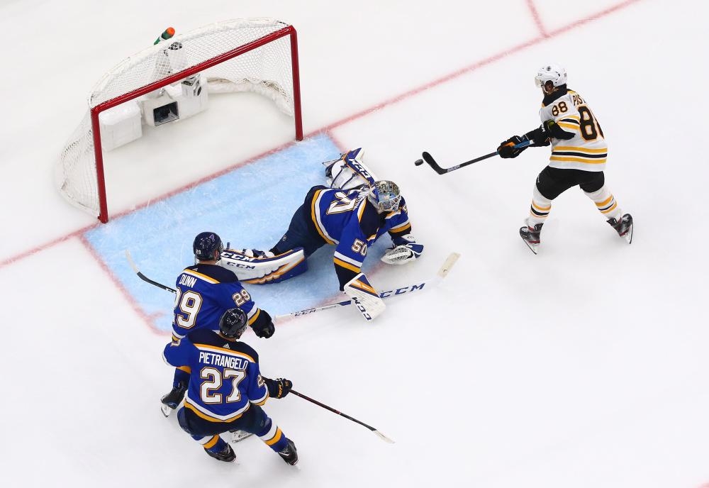 David Pastrnak No. 88 of the Boston Bruins scores a third period goal past Jordan Binnington No. 50 of the St. Louis Blues in Game Six of the 2019 NHL Stanley Cup Final at Enterprise Center on June 09, 2019 in St Louis, Missouri. — AFP