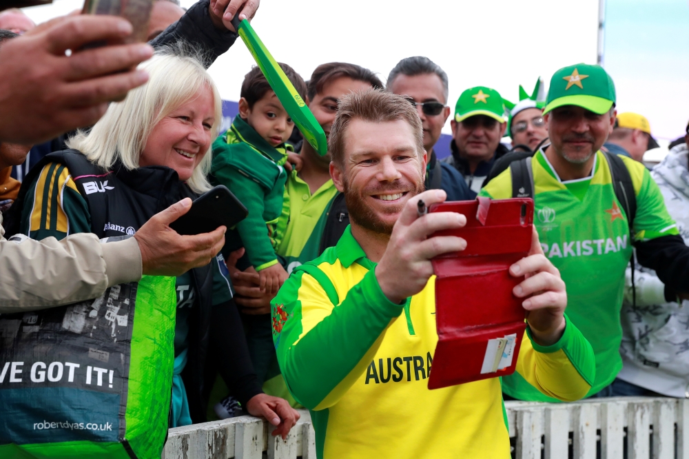Australia's David Warner poses for a photo with fans after the ICC Cricket World Cup match with Pakistan at the The County Ground, Taunton, Britain, on Wednesday. —  Reuters