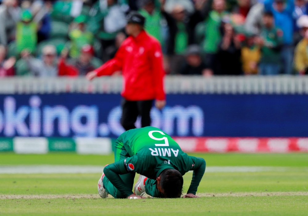 Pakistan's Mohammad Amir and teammates after Australia's innings in the ICC Cricket World Cup match at the County Ground, Taunton, Britain, on Wednesday. — Reuters