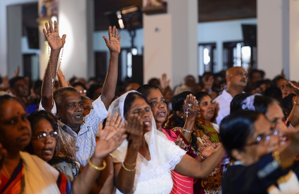 Sri Lankan Christian devotees pray during a mass at St. Anthony's church in Colombo on Thursday, after a series of deadly Easter Sunday blasts targeting churches and luxury hotels. — AFP