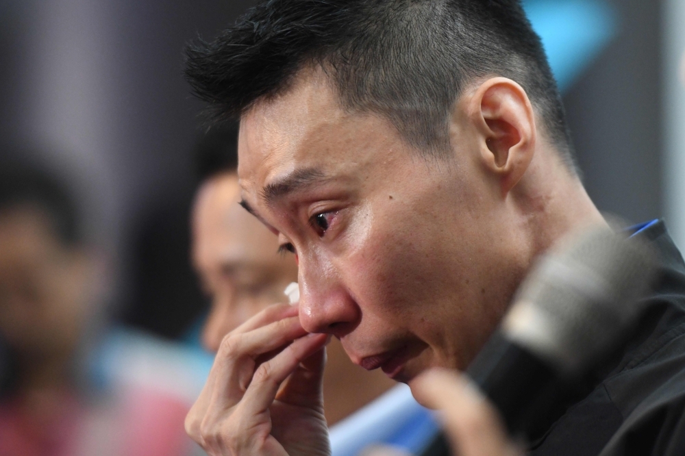 Malaysia's badminton player Lee Chong Wei reacts during a press conference to announce his retirement in Putrajaya on Thursday. — AFP