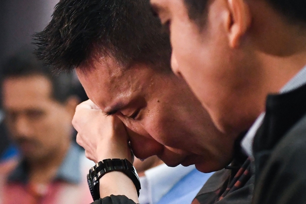 Malaysia's badminton player Lee Chong Wei reacts during a press conference to announce his retirement in Putrajaya on Thursday. — AFP