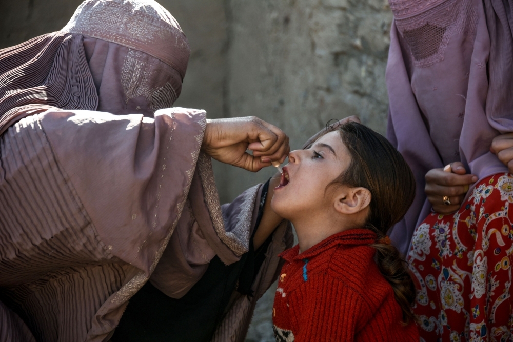 In this photo taken on March 20, 2019, an Afghan health worker administers a polio vaccine to a child in Kandahar province's Arghandab district. Polio immunization is compulsory in Afghanistan, but distrust of vaccines is rife, and the programs are difficult to enforce particularly in rural regions. — AFP