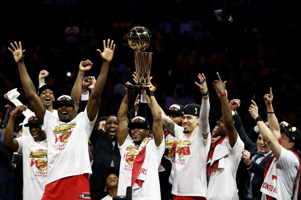 Kawhi Leonard No. 2 of the Toronto Raptors celebrates with the Larry O'Brien Championship Trophy after his team defeated the Golden State Warriors to win Game Six of the 2019 NBA Finals at ORACLE Arena on Thursday in Oakland, California. — AFP