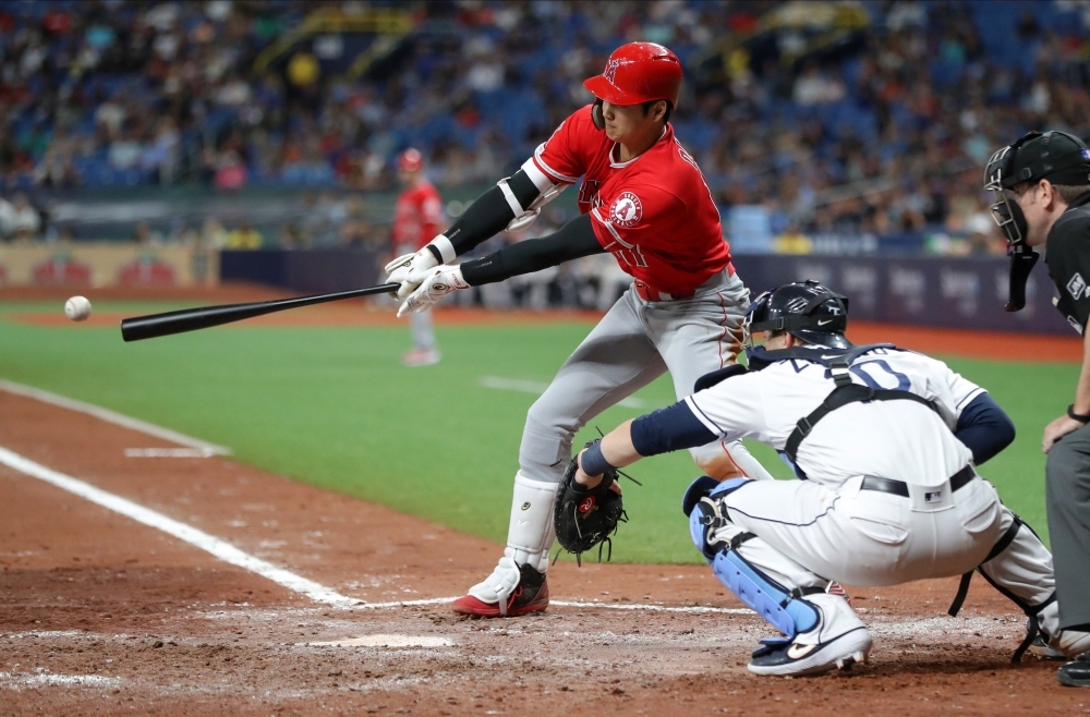 Los Angeles Angels designated hitter Shohei Ohtani (17) is congratulated by teammates in the dugout after a single during the seventh inning to hit for the cycle against the Tampa Bay Rays at Tropicana Field. — Reuters