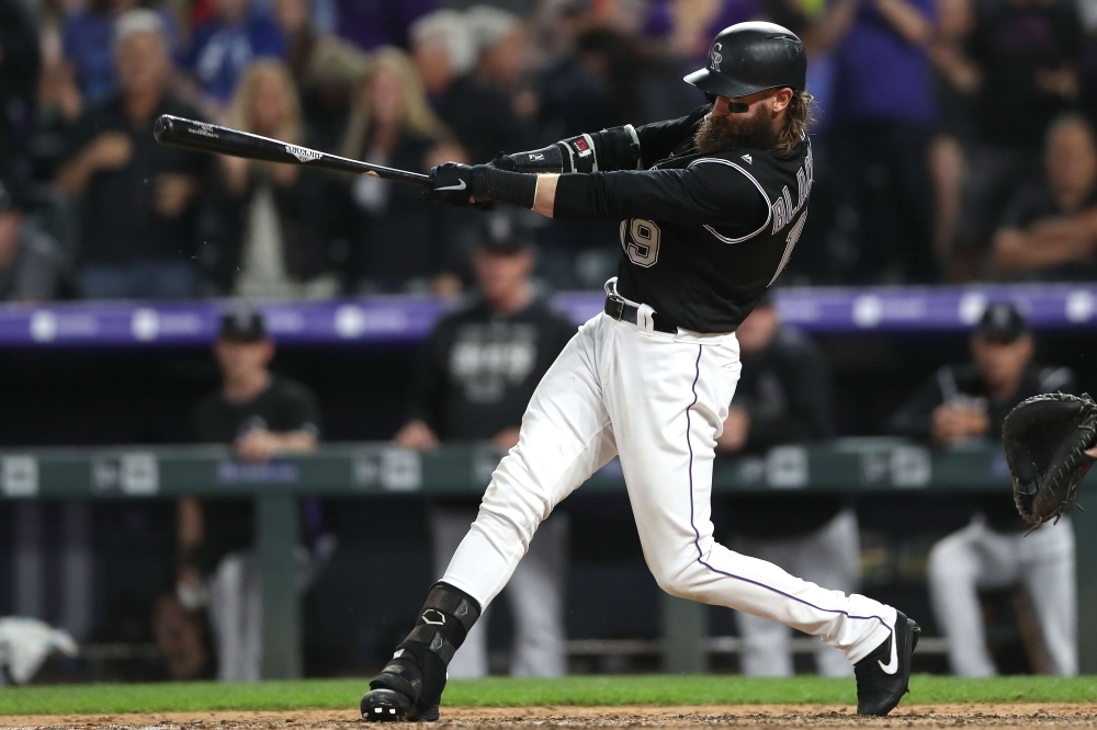 Charlie Blackmon No. 19 of the Colorado Rockies hits a double in the sixth inning against the San Diego Padres at Coors Field on Friday in Denver, Colorado. — AFP