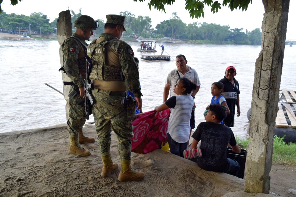 Members of naval police talk to people that crossed the Suchiate river on a raft from Tecun Uman in Guatemala to Ciudad Hidalgo, Mexico on June 16, 2019. — Reuters