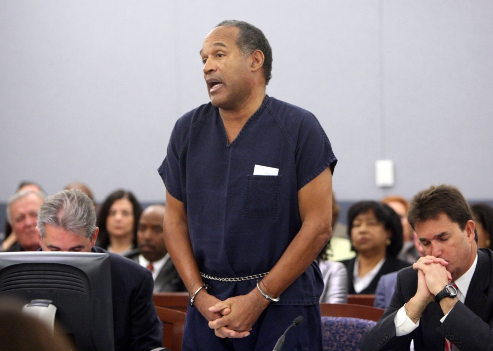 OJ Simpson speaks in court prior to his sentencing as his attorneys Gabriel Grasso, left, and Yale Galanter listen at the Clark County Regional Justice Center in Las Vegas, Nevada, in this Dec. 4, 2008 file photo. — AFP