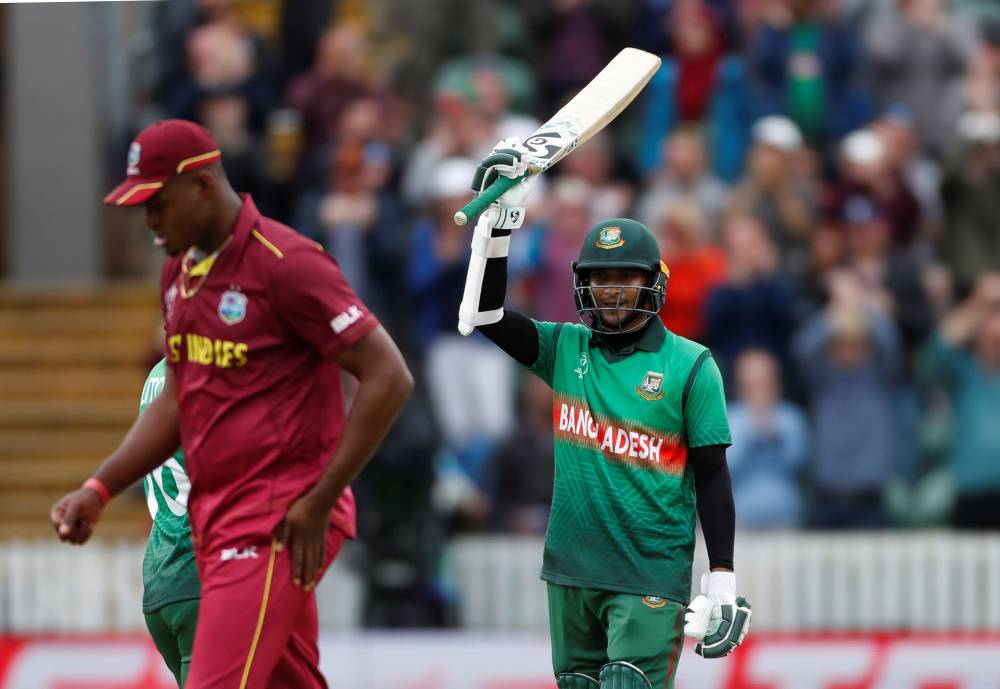 Bangladesh's Shakib Al Hasan celebrates reaching his century during the Cricket - ICC Cricket World Cup against West Indies at The County Ground, Taunton, Britain on Monday. — Reuters