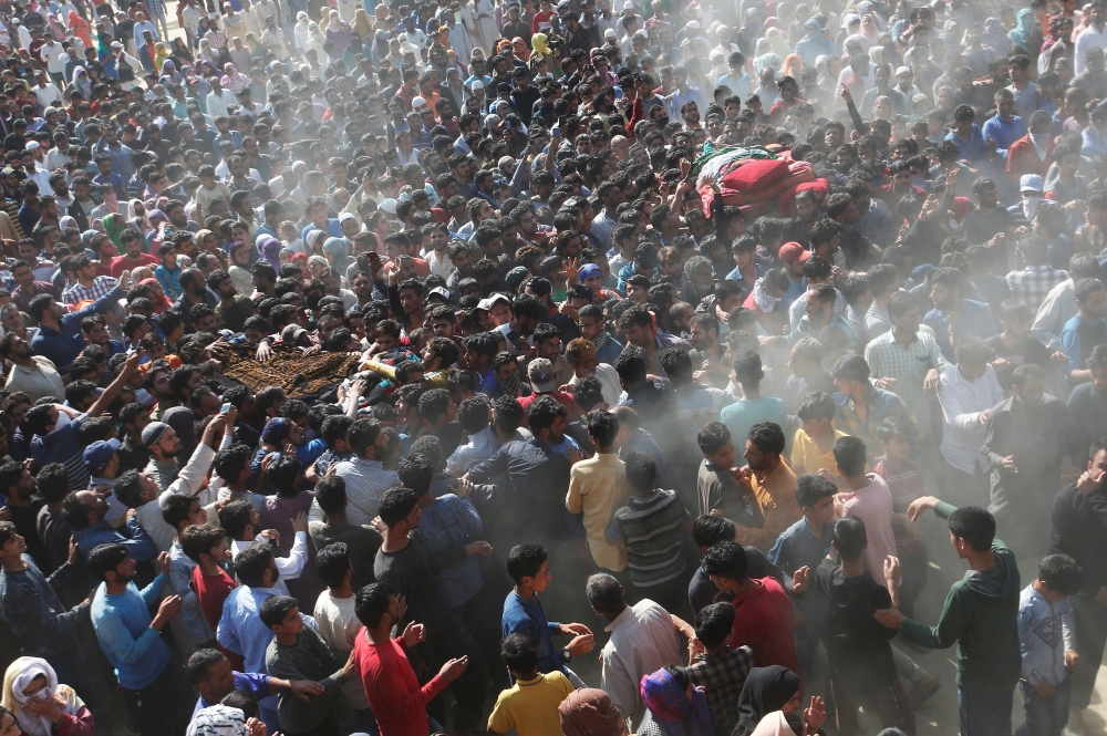 People carry the bodies of Sajjad Ahmad Bhat and Tawseef Ahmad Bhat, suspected militants, who were killed during a gun battle with Indian security forces today, according to local media, during their funeral procession in Marhama village in South Kashmir's Anantnag district on Tuesday. — Reuters