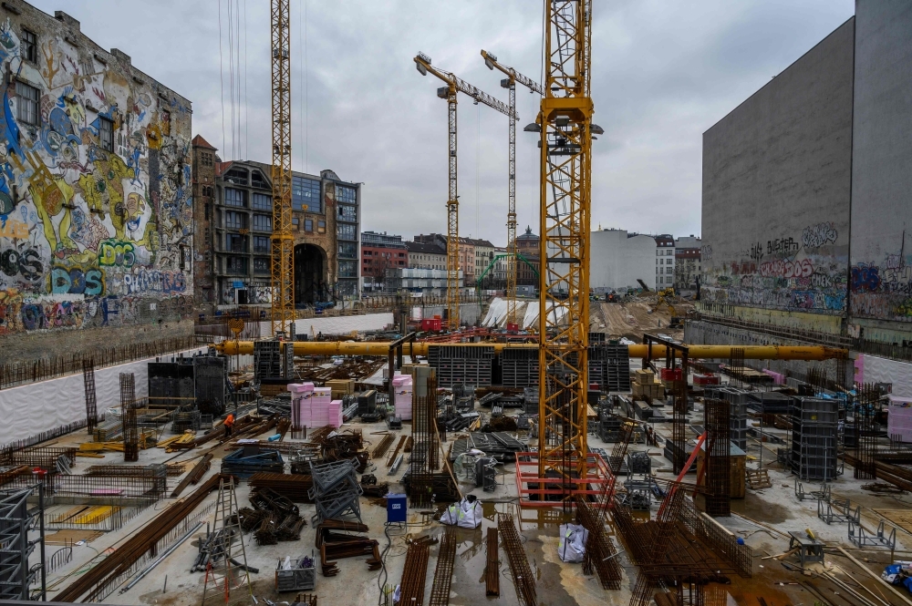 Cranes operate at a construction site on Berlin's Friedrichstrasse, a 25,300 square-meter site in central Berlin, which includes the old Tacheles artist colony (building 2nd from left), that is being redeveloped to include retail space, offices and residential units, designed by Swiss architects firm Herzog & De Meuron in this Feb. 19, 2019 file photo. — AFP