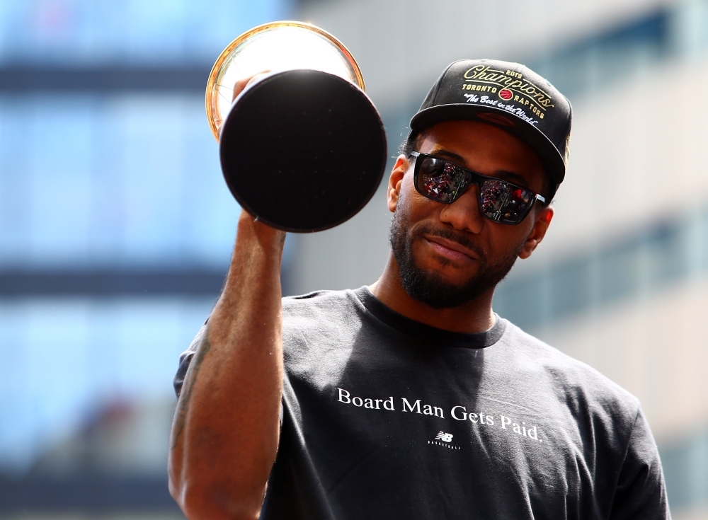 Kawhi Leonard No. 2 of the Toronto Raptors holds the MVP trophy during the Toronto Raptors Victory Parade on Monday in Toronto, Canada. The Toronto Raptors beat the Golden State Warriors 4-2 to win the 2019 NBA Finals. — AFP