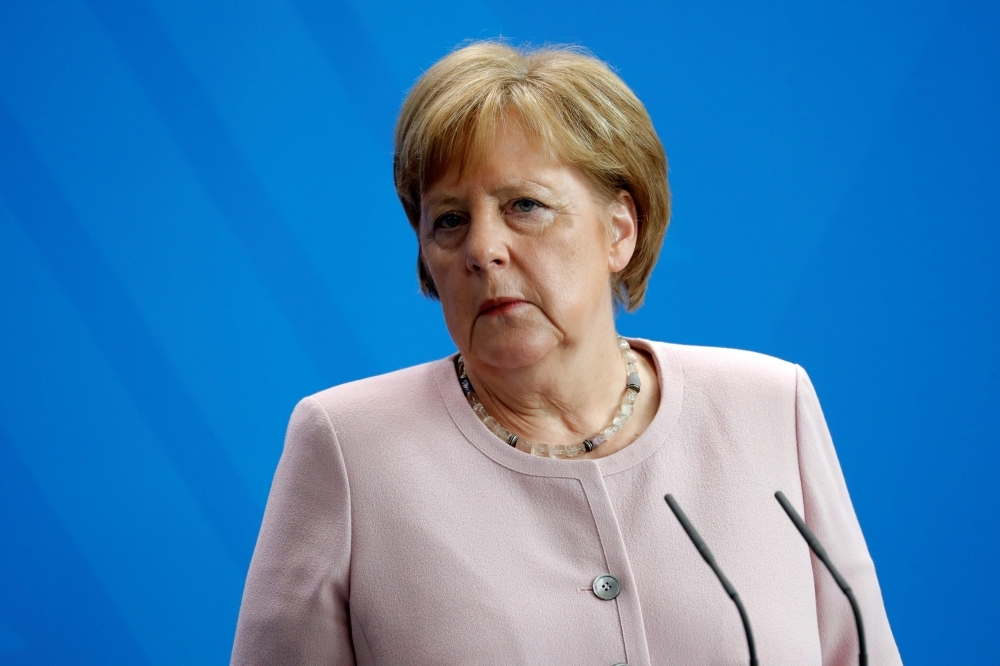 German Chancellor Angela Merkel looks on during a press conference with Ukraine's new president on his first official visit to Germany at the Chancellery in Berlin on Tuesday. — AFP