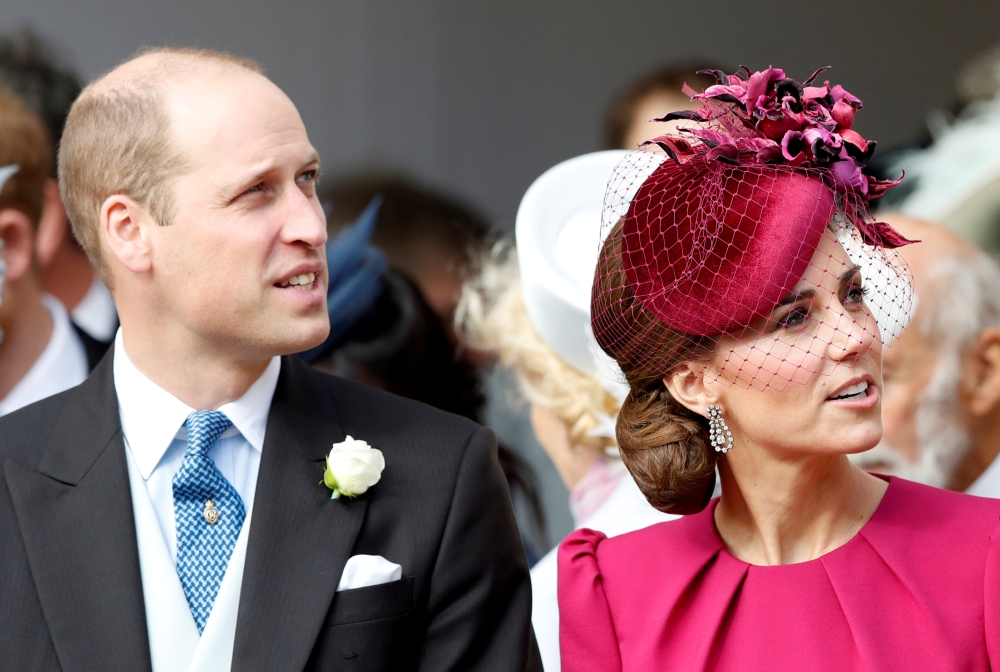 Prince William and Kate, Duchess of Cambridge, look up at the Royal Standard flying from the round tower following the wedding of Princess Eugenie of York and Jack Brooksbank in St. George's Chapel, Windsor Castle, near London, in this Oct. 12, 2018 file photo. — Reuters