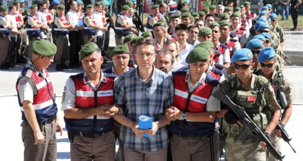 Arrested soldiers accused of participating in the attempted coup last year are being accompanied by Turkish police as they arrive for their trial at Sincan Penal Institution near Ankara in this file photo. — AFP