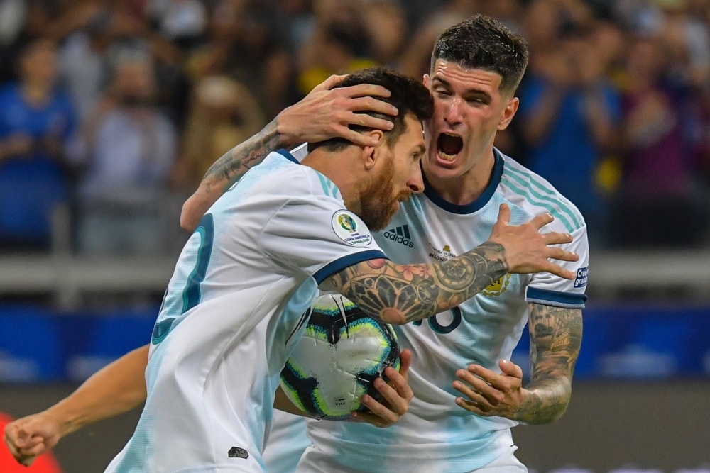 Argentina's Lionel Messi (L) celebrates with teammate Rodrigo De Paul after scoring a penalty against Paraguay which was awarded by the VAR during their Copa America football tournament group match at the Mineirao Stadium in Belo Horizonte, Brazil, on Wednesday. — AFP