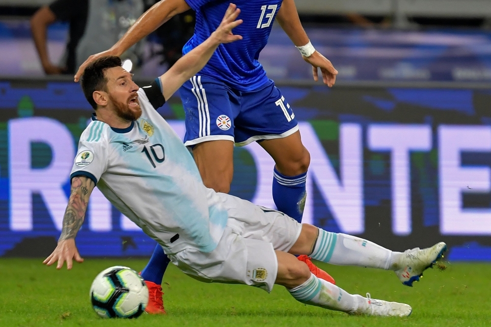 Argentina's Lionel Messi (L) celebrates with teammate Rodrigo De Paul after scoring a penalty against Paraguay which was awarded by the VAR during their Copa America football tournament group match at the Mineirao Stadium in Belo Horizonte, Brazil, on Wednesday. — AFP