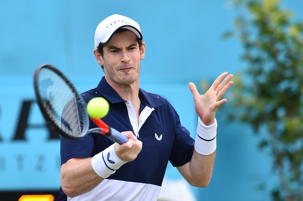 Britain's Andy Murray returns to Colombia's Juan Sebastian Cabal and Robert Farah during a first round doubles match at the ATP Fever-Tree Championships tennis tournament at Queen's Club in west London on Thursday. — AFP