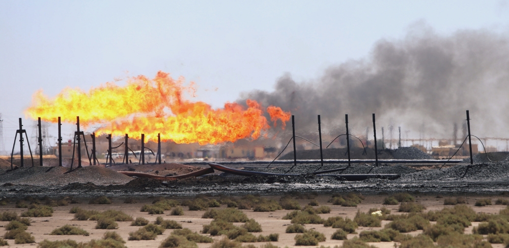 Flames emerge from the flare stacks at the West Qurna-1 oilfield, which is operated by ExxonMobil, near Basra, Iraq, on June 1, 2019.  — Reuters