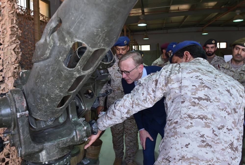 Brian Hook (C), the US special representative on Iran, listens to a Saudi official as they check what Saudi officials said was an Iranian-made launcher used by the Houthi rebels in Yemen, during a visit to an army base in Al-Kharj, south of the Saudi capital Riyadh, on Friday. — AFP