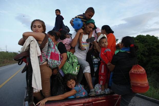 A man carrying a small child is forced to get off a pickup truck, at the request of the driver who is giving a free ride only to women with children, as the migrant caravan moves away from San Pedro Tapanatepec, Oaxaca state, Mexico, in this file photo. – Courtesy photo