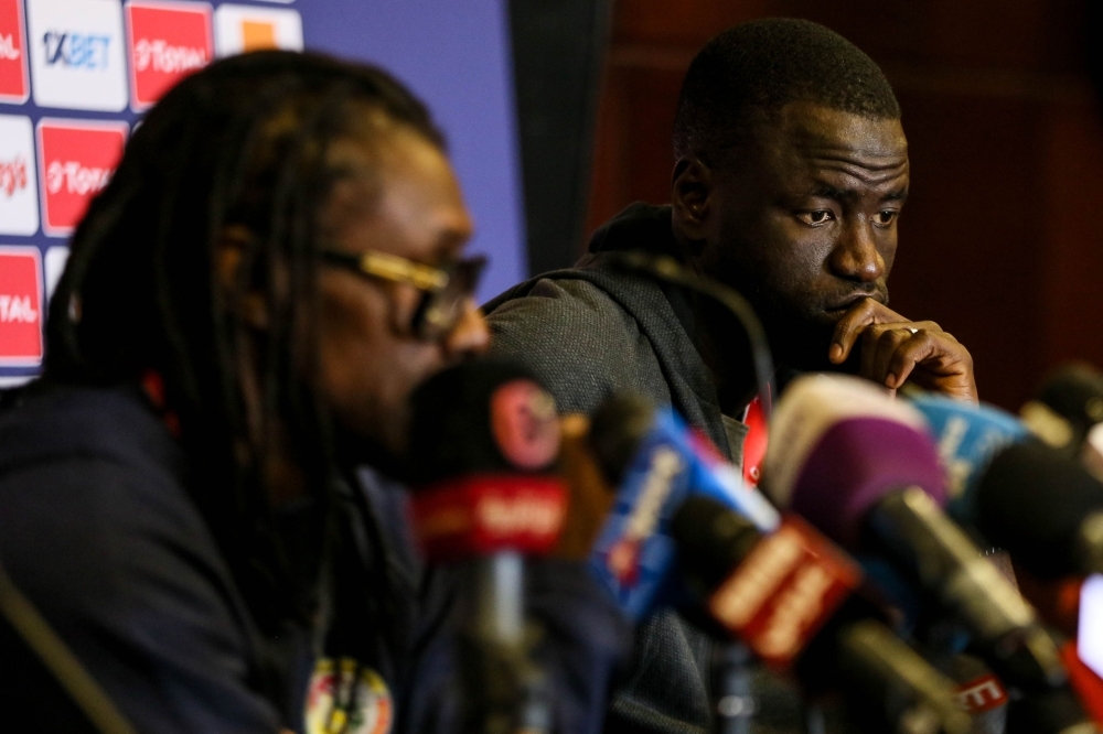 Senegal's defender Cheikhou Kouyate (R) listens to Senegal's coach Aliou Cisse during a presser at the 30 June stadium in Cairo on Saturday, on the eve of the 2019 Africa Cup of Nations (CAN) football match against Tanzania. — AFP