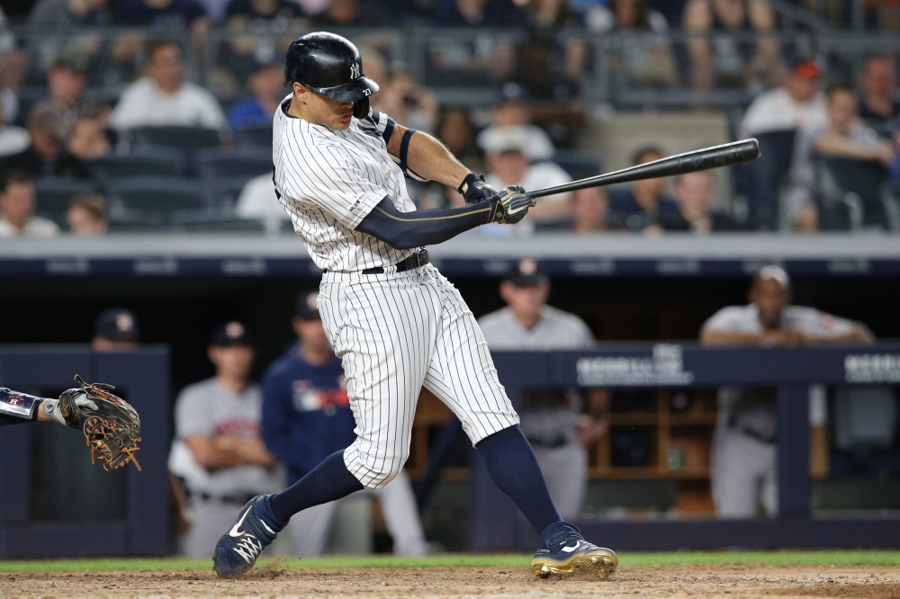 New York Yankees left fielder Giancarlo Stanton (27) hits a two run single against the Houston Astros during the seventh inning at Yankee Stadium. — Reuters