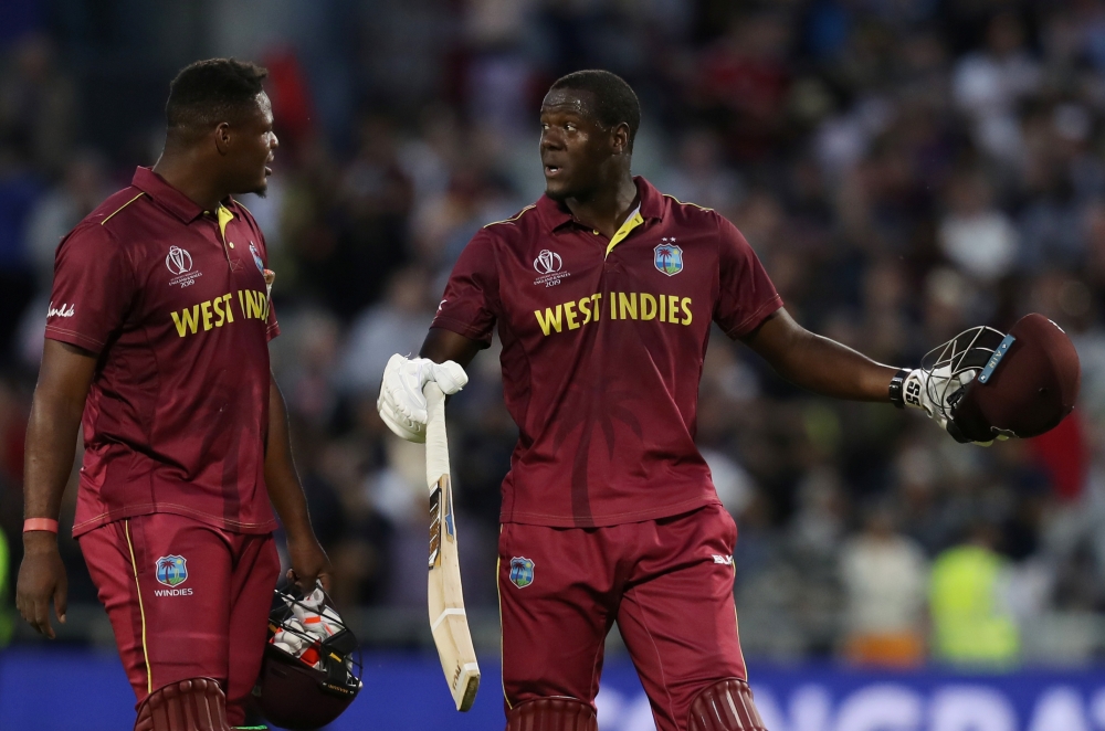 West Indies' Carlos Brathwaite and Oshane Thomas look dejected after losing the match against New Zealand in the ICC Cricket World Cup at Old Trafford, Manchester, Britain on Saturday. — Reuters