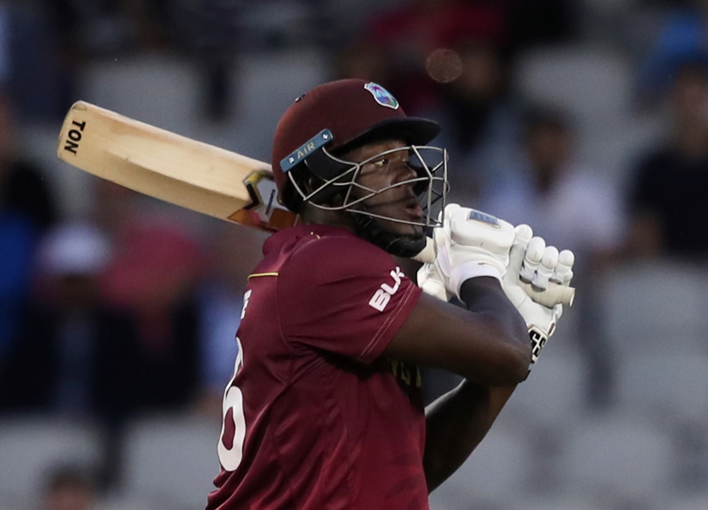 West Indies' Carlos Brathwaite and Oshane Thomas look dejected after losing the match against New Zealand in the ICC Cricket World Cup at Old Trafford, Manchester, Britain on Saturday. — Reuters