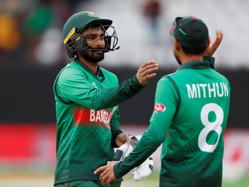 Bangladesh's Liton Das and Mohammad Mithun celebrate at the end of the match against West Indies during the ICC Cricket World Cup match at The County Ground, Taunton, Britain. — Reuters