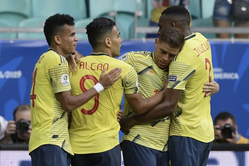 Colombia's Gustavo Cuellar (C) strikes to score past Paraguay's goalkeeper Roberto Fernandez (L) and defender Junior Alonso during their Copa America football tournament group match at the Fonte Nova Arena in Salvador, Brazil, on Sunday. — AFP