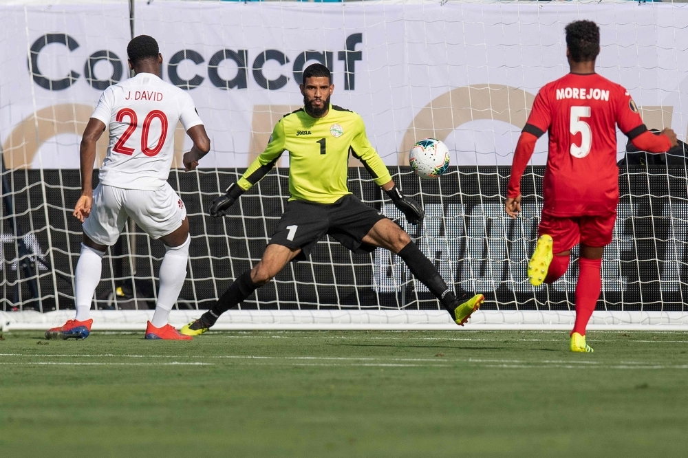 Canada's Lucas Cavallini (C) celebrates after scoring a goal on Cuba's Sandy Sanchez (R) as Yosel Piedra (L) looks on during their CONCACAF Gold Cup group stage football match at Bank of America Stadium in Charlotte, North Carolina, on Sunday. — AFP