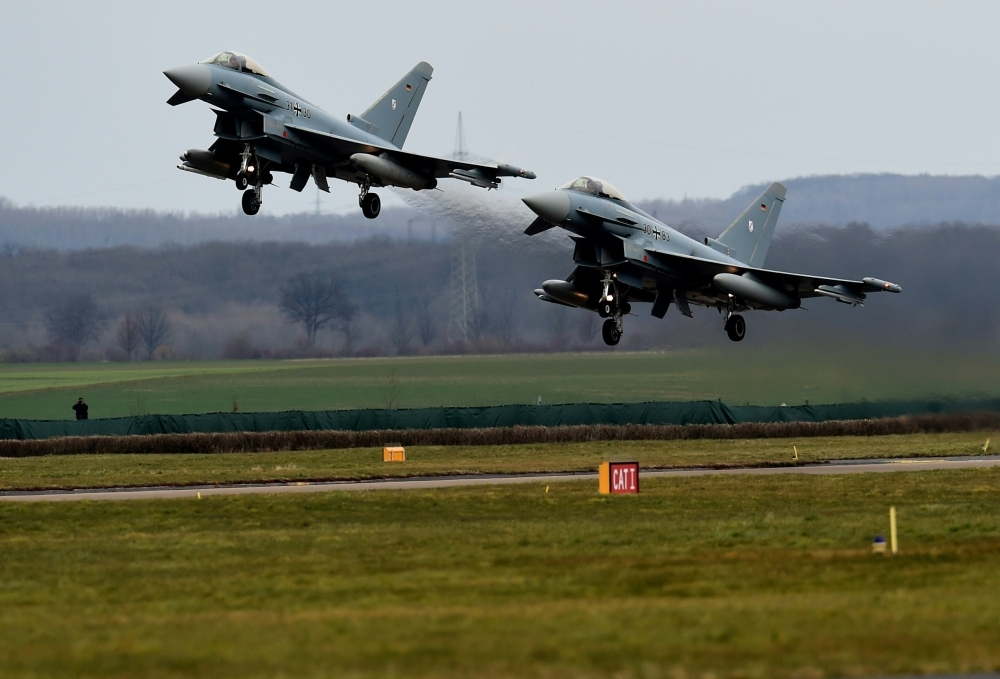 Two Eurofighters take off for a demonstration flight at the German Air Force airbase Noervenich, near Cologne, in this March 21, 2016 file photo. — AFP