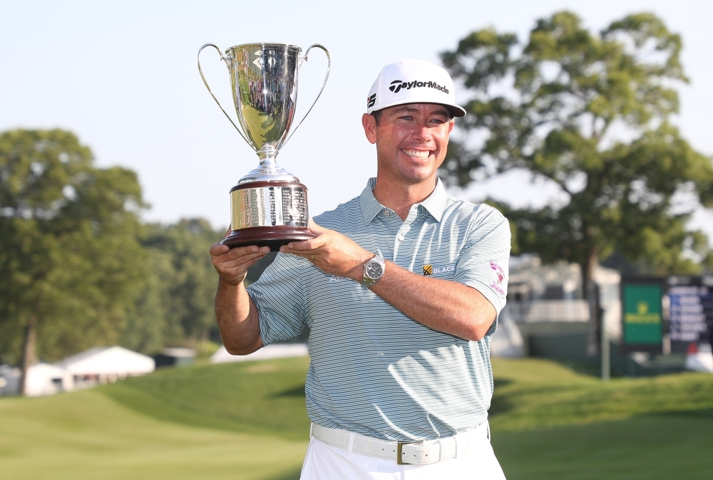 Chez Reavie of the United States poses with the trophy after winning the Travelers Championship at TPC River Highlands on Sunday in Cromwell, Connecticut. — AFP