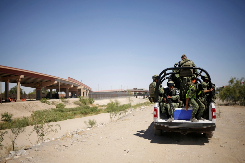 Members of Mexico's National Guard patrol the border between Mexico and the US as part of an ongoing operation to prevent migrants from crossing illegally into the United States, in Ciudad Juarez, Mexico, on Monday. — Reuters