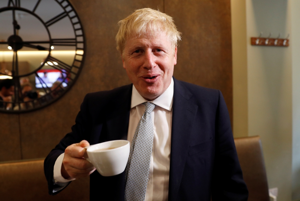Boris Johnson, a leadership candidate for Britain's Conservative Party, visits a tea shop in Oxshott, Surrey, Britain, on Tuesday. — Reuters