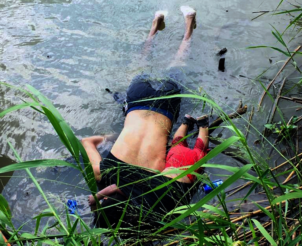 View of the bodies of Salvadoran migrant Oscar Martinez Ramirez and his daughter, who drowned while trying to cross the Rio Grande in Matamoros, state of Coahuila on Monday. -AFP