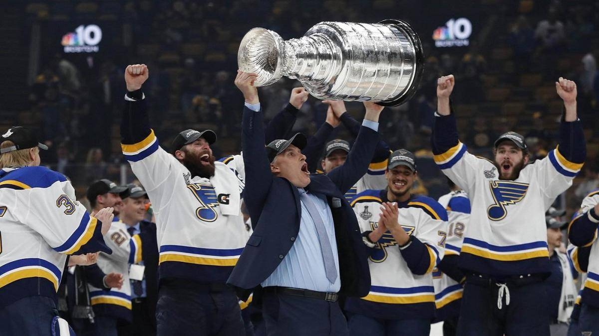 St. Louis Blues head coach Craig Berube hoists the Stanley Cup after defeating the Boston Bruins in game seven of the 2019 Stanley Cup Final at TD Garden. Berube, who led the St. Louis Blues to the Stanley Cup as an interim head coach, signed a three-year contract Tuesday to stay with the team. — Reuters