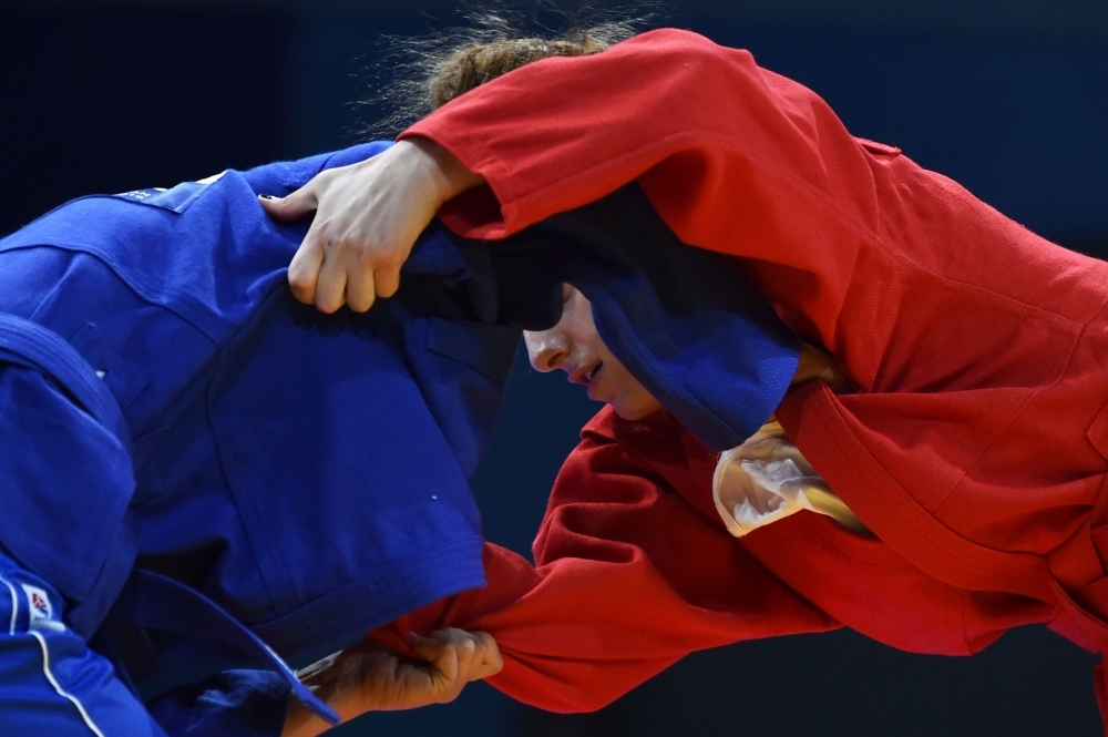 Spectators watch sambo competitions at the 2019 European Games in Minsk on Sunday. With elements of judo, karate, boxing, Greco-Roman wrestling and more, sambo was created to train the forces of the Soviet Union and is still taught in the Russian army. The combat sport, which dates back to 1930, has caught attention this month as part of the European Games in Minsk. Now its backers are targeting the 2024 Olympic Games in Paris. — AFP