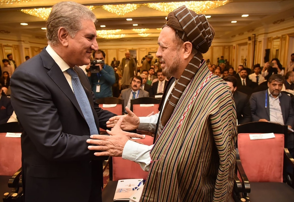 Pakistan's Foreign Minister Shah Mahmood Qureshi, left, greets with Afghan legislator Mohammad Mohaqiq, right, before a peace conference in Bhurban, Pakistan, in this June 22, 2019 file photo. Senior Afghan political leaders attended the peace conference in Bhurban ahead of President Ashraf Ghani’s visit to Islamabad. — AFP