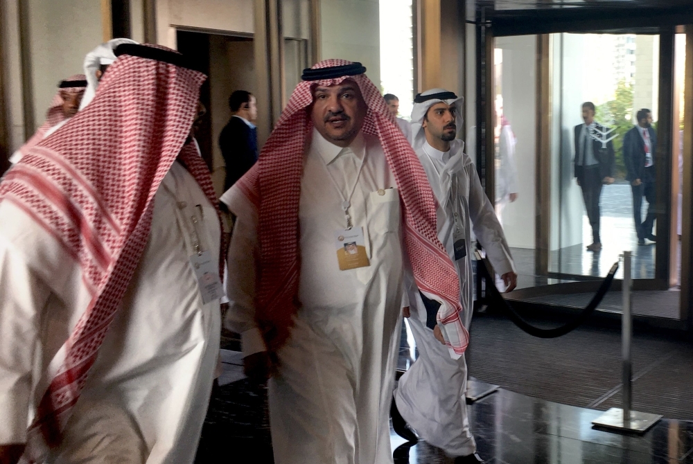 Saudi Minister of State Mohammed Al-Shaikh (C) arrives for the second day of a US-sponsored Middle East economic conference in Manama on Wednesday. — AFP