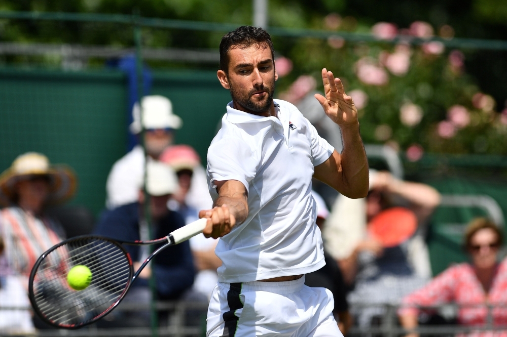 Croatia's Marin Cilic (R) speaks with Spain's Rafael Nadal after winning their men's singles match at The Aspall Tennis Classic tournament at the Hurlingham Club in London on Wednesday. — AFP