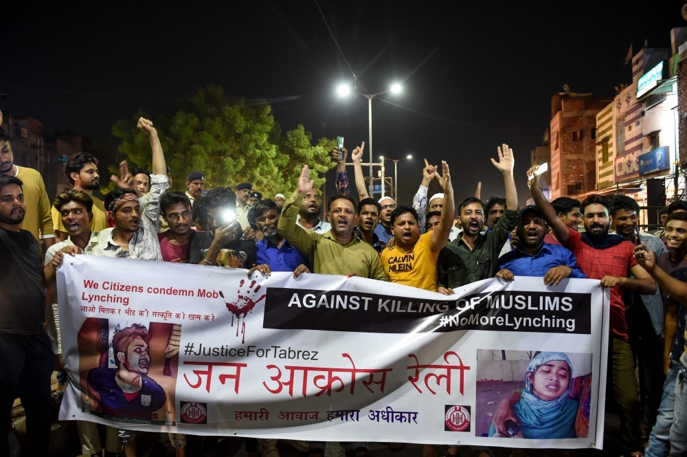 Indian Muslims hold a banner as they protest against the mob lynching of Tabrez Ansari in the Jharkhand state in Ahmedabad, Gujarat, on Wednesday. — AFP