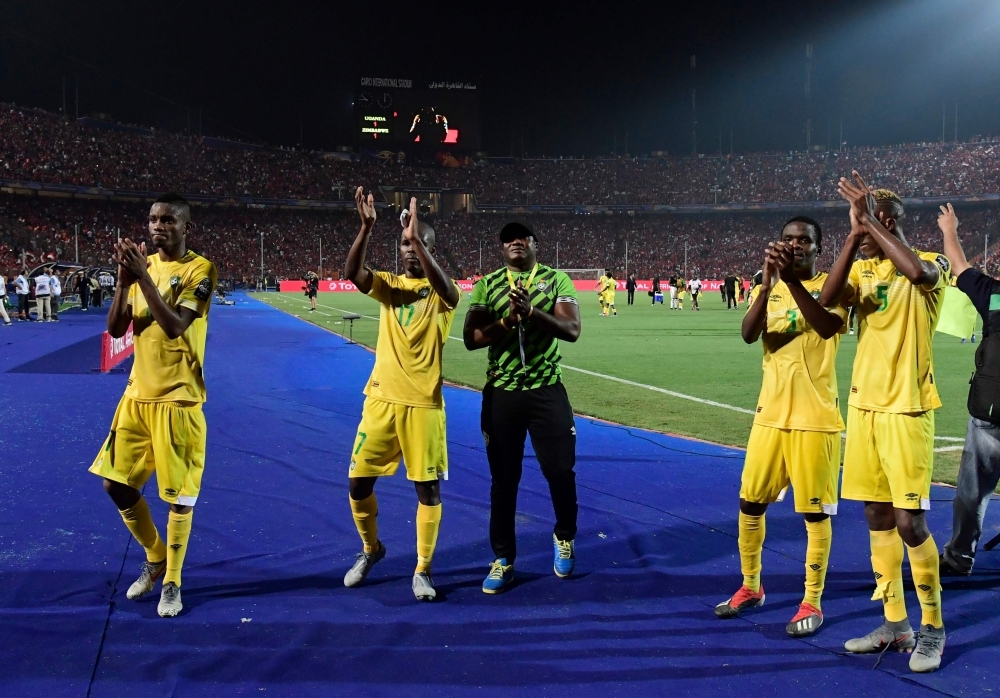 Zimbabwe players greet their fans after the 2019 Africa Cup of Nations (CAN) football match between Uganda and Zimbabwe at the Cairo International Stadium on Wednesday. — AFP