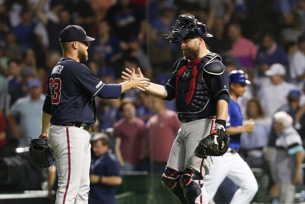 A.J. Minter #33 of the Atlanta Braves and Brian McCann #16 celebrate their team's 5-3 win over the Chicago Cubs at Wrigley Field in Chicago, Illinois, on Wednesday. — AFP